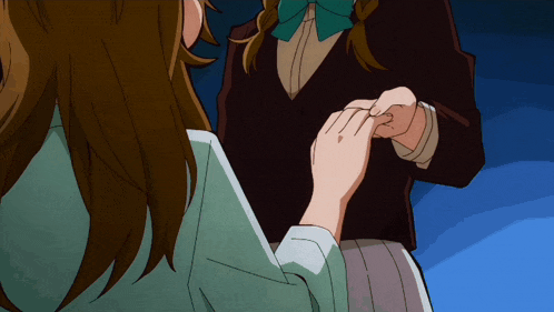 a woman is putting a ring on another person 's finger