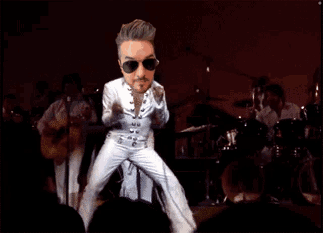 a cartoon of a man wearing sunglasses and a white suit dancing on a stage