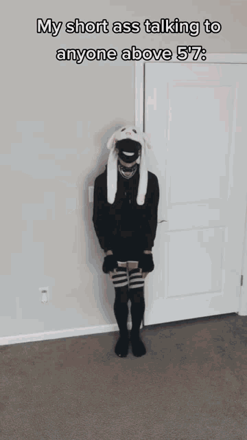 a person wearing a bunny hat and knee high socks is talking to anyone above 5 '7 "