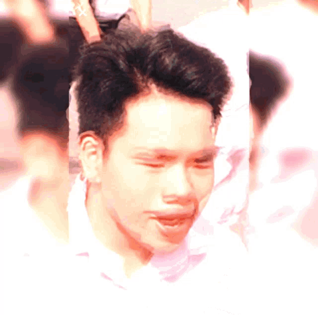 a close up of a man 's face with a pink background
