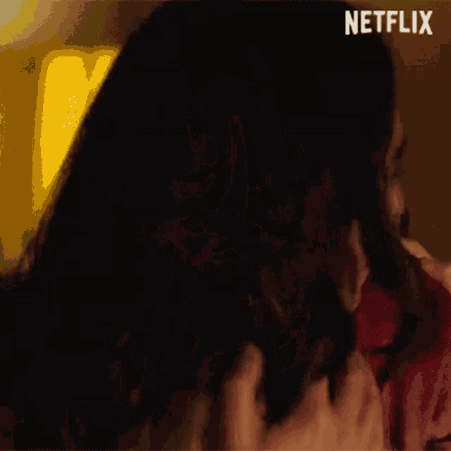a man is touching a woman 's hair in a netflix advertisement .