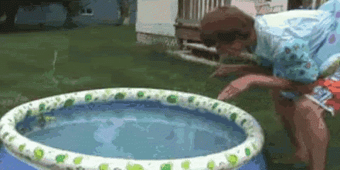 a person is standing next to a small inflatable pool .