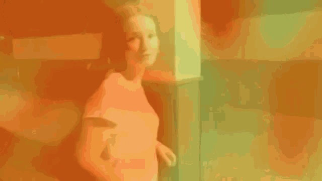 a person is standing in a room with orange smoke coming out of them .