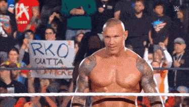 a man in a wrestling ring with a sign that says rko cutta