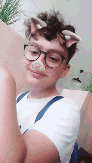 a young boy wearing glasses and cat ears