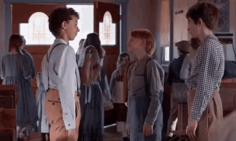 a group of children are standing next to each other in a church .