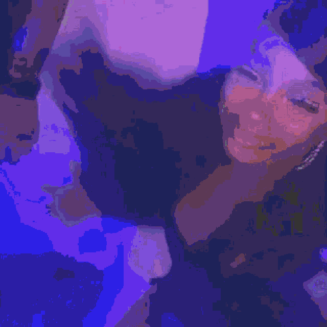 a close up of a woman 's face with a blurry background and a purple background .