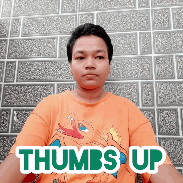 a man wearing a shirt that says thumbs up on it