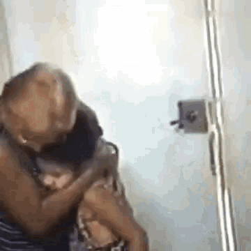 a woman is holding a child in her arms in a room .