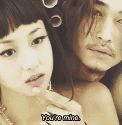a man and a woman are standing next to each other and the woman says you 're mine