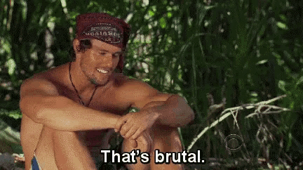 a shirtless man is sitting in the woods and saying that 's brutal