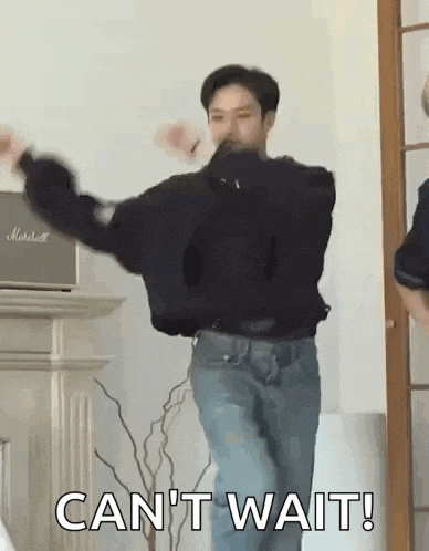 a man is dancing in a living room with the words `` can 't wait '' written on the bottom .