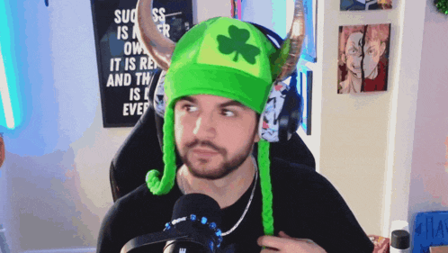 a man wearing a green hat with horns and a shamrock on it