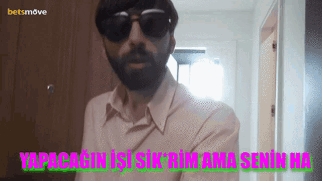 a man with a beard wearing sunglasses and a betsmove logo on the bottom