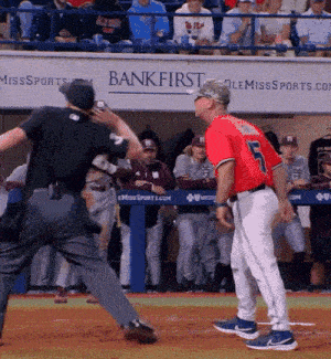 a baseball game is being played in front of a bank first sign