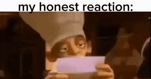 a chef is holding a piece of paper in front of his face .