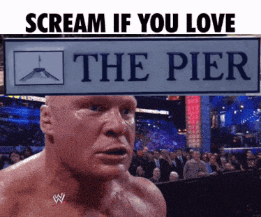 brock lesnar is screaming in front of a sign for the pier