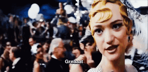a woman is standing in front of a crowd and says greaat