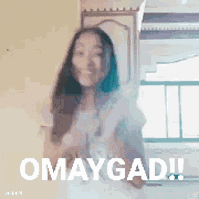 a woman is dancing in front of a window with the word omag ad written on the bottom