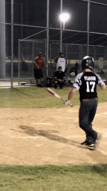 a baseball player with the number 17 on his back is swinging a bat