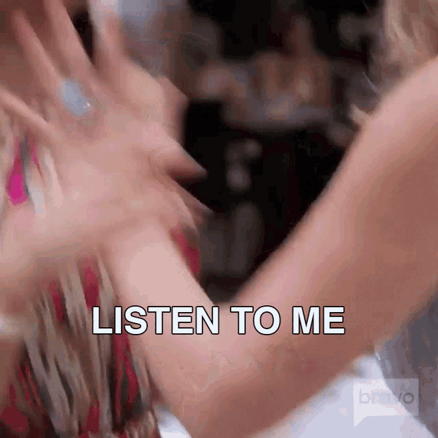 a blurry picture of two women dancing with the words listen to me in the foreground
