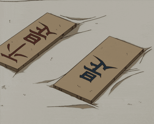 a bird is looking at two pieces of wood with chinese writing