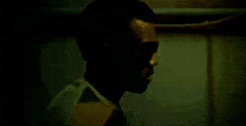 a close up of a man 's face with a light shining on it .