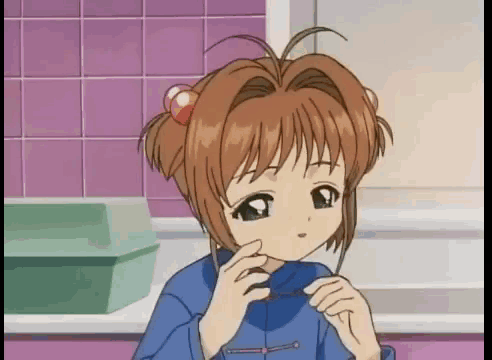 a girl in a blue shirt is holding a piece of paper in her hands