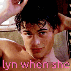 a shirtless man is sitting on a couch with his hands in his hair and the caption lyn when she