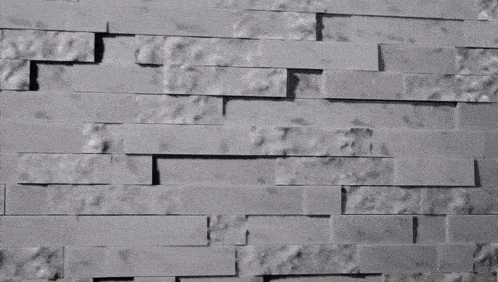 a close up of a brick wall with a few bricks missing