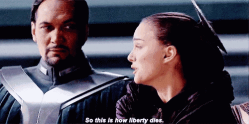 a man and a woman are standing next to each other and the woman is saying `` so this is how liberty dies '' .