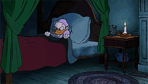 a cartoon of a duck in a bed with a candle on a nightstand