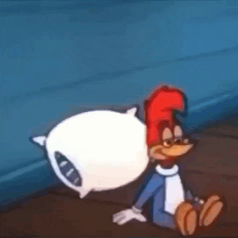 woody woodpecker is sitting on the floor with a pillow .