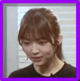 a close up of a woman 's face with a purple border around it .