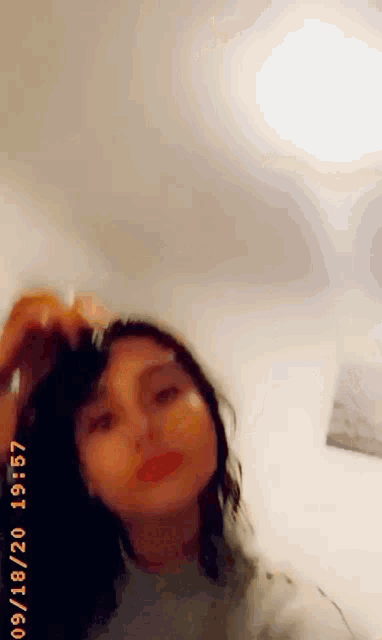 a woman is taking a picture of herself with the date 09 18 20 on the bottom right corner .
