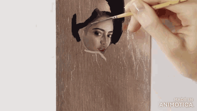 a person is painting a woman 's face with a brush and the words made in animatica are visible