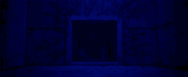 a man in a mask is crawling out of a hole in the wall