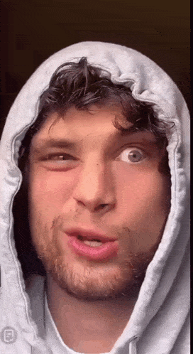 a close up of a man wearing a hooded sweatshirt
