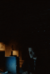 a man sits at a desk in front of a computer screen