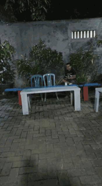 a man sits on a bench eating a meal