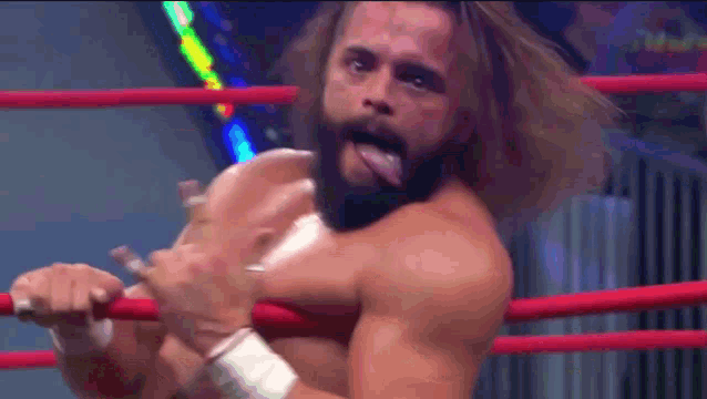 a man with a beard is sticking his tongue out in a ring