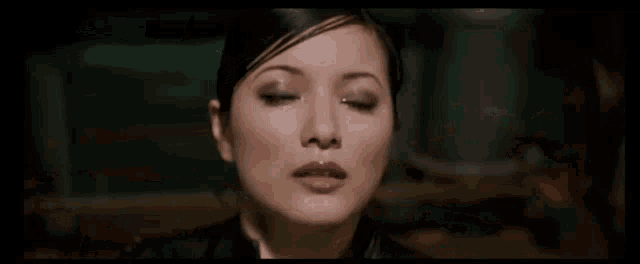 a woman with her eyes closed and sweat on her face