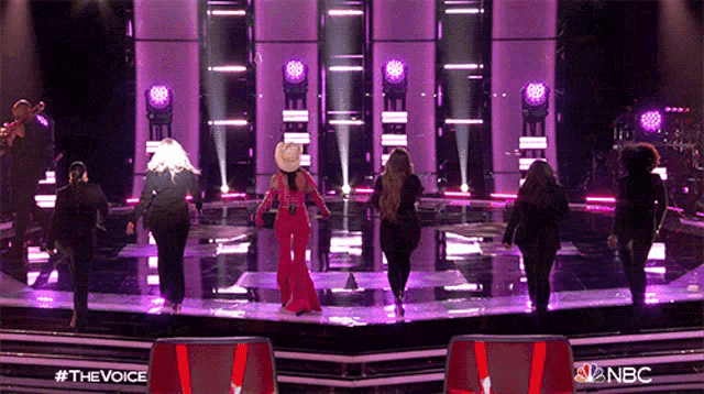 a group of women are dancing on a stage with nbc written on the bottom right