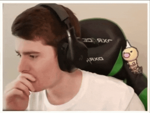 a man wearing headphones is sitting in a chair with the word axc on it