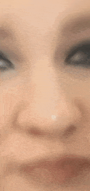 a close up of a woman 's face with a headset on her head .