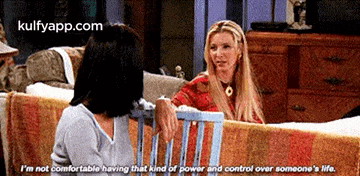 two women are sitting next to each other on a couch and one of them says i 'm not comfortable