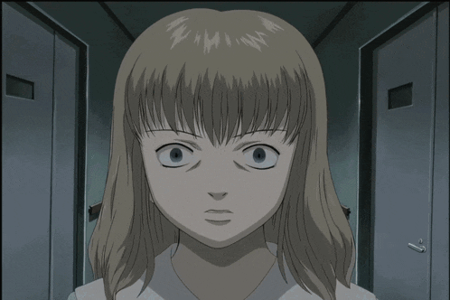a close up of a girl 's face with a very serious look on her face