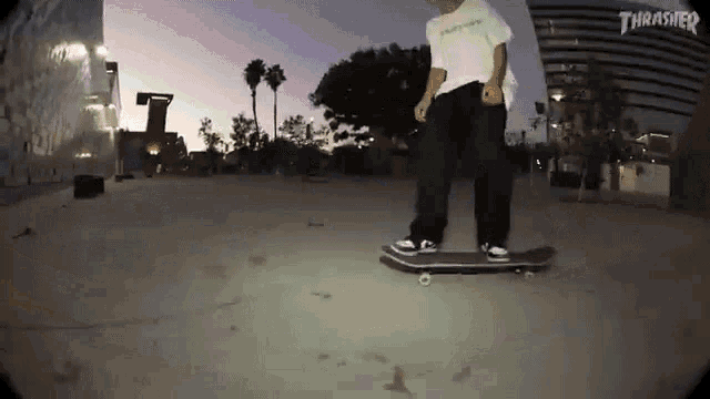 a person is riding a skateboard in front of a thrasher logo