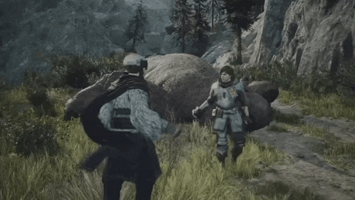 two soldiers are walking in a field with a large rock in the background .
