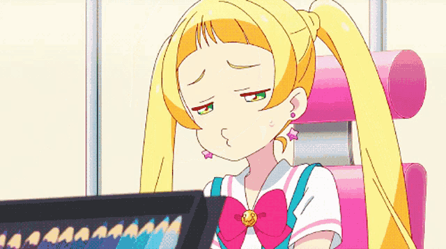 a girl with yellow hair and a pink bow is sitting in front of a computer monitor